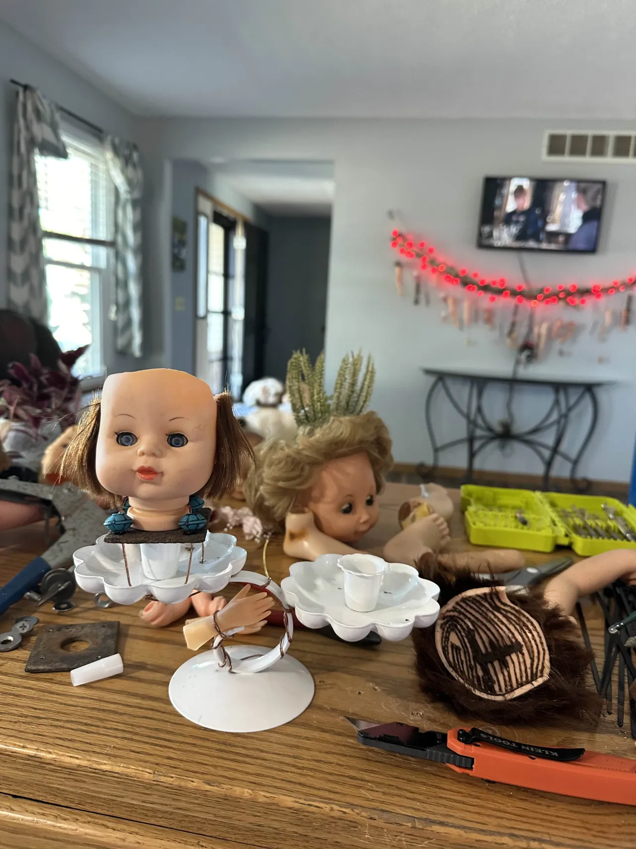 Workshop table with doll parts and tools